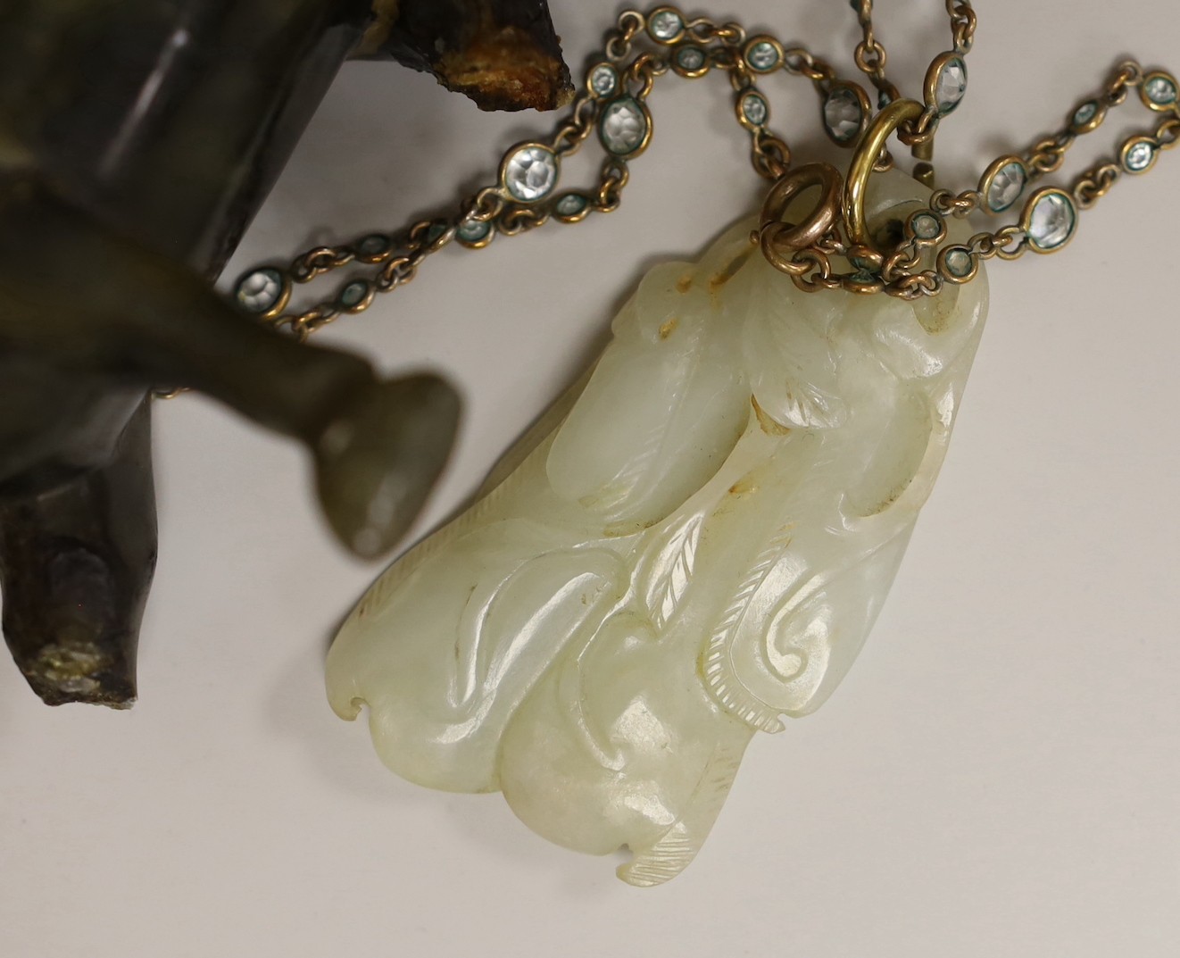 A 19th century Chinese pale celadon jade pendant a Chinese blanc de Chine figure, two soapstone horses and an Indian vase, figure 17cms high